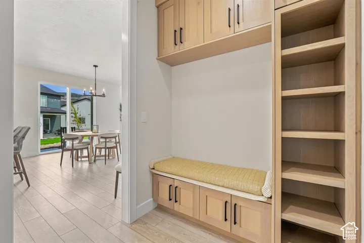 Enter from the garage, Built-in storage bench with lower cabinetry, open shelving and upper cabinetry