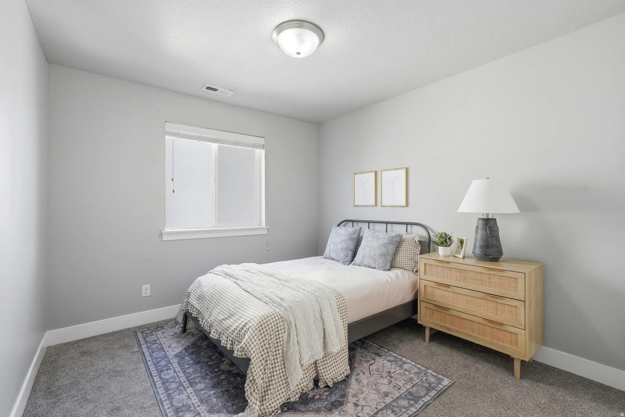 Recessed window with white trim, gray wall paint, and gray carpeting