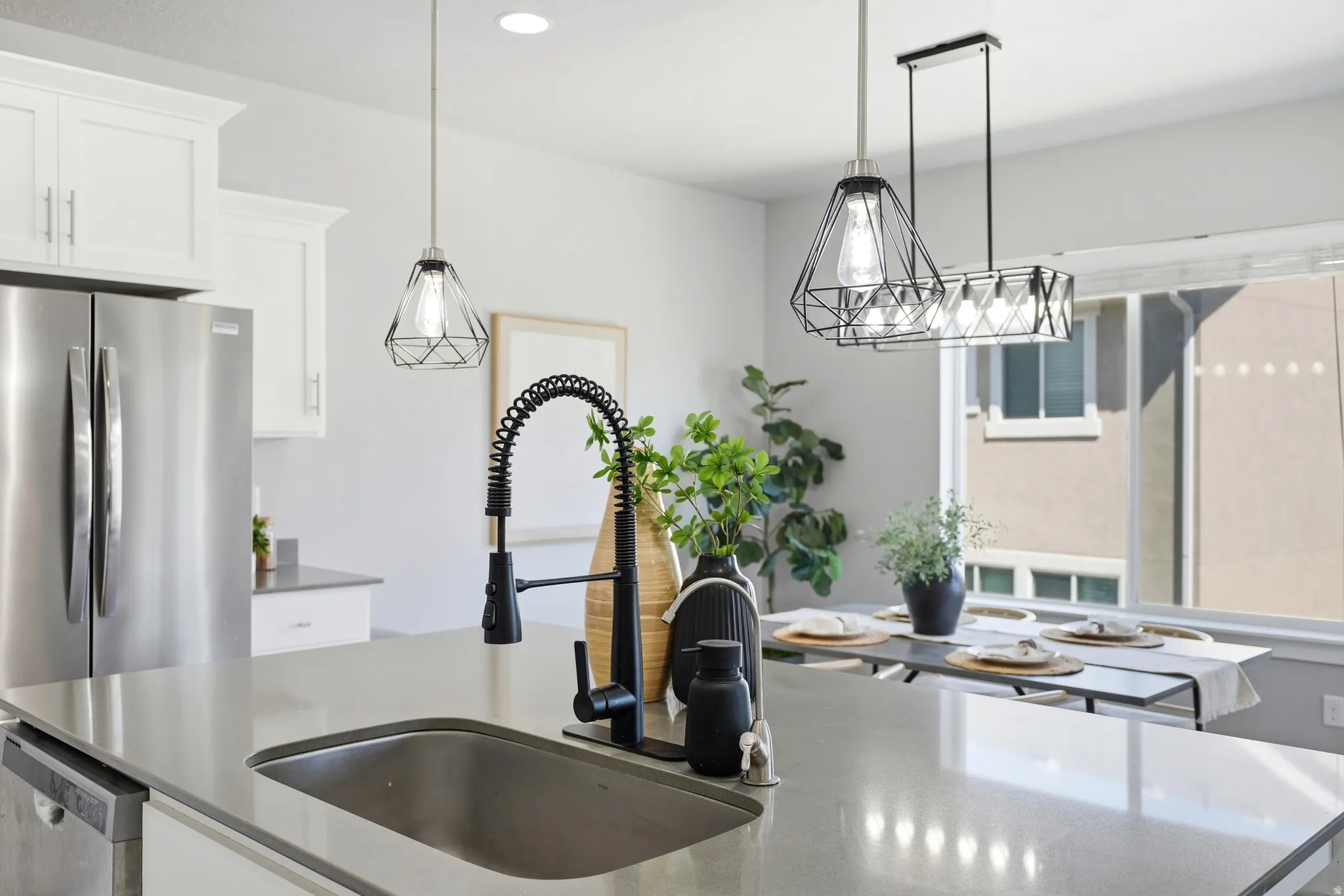 Kitchen island with an undermount sink and matte black pull-down faucet