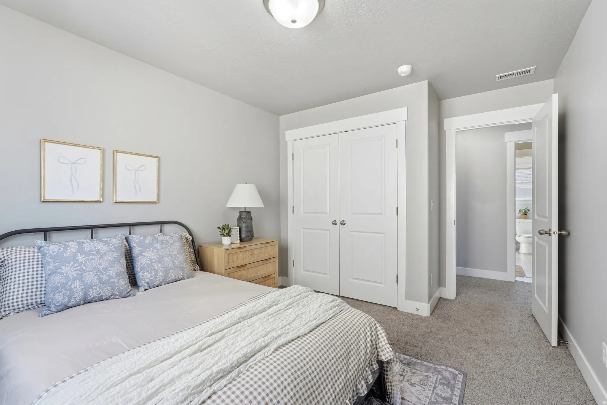 Carpeted flooring, paneled interior doors, and a flush mount ceiling light fixture