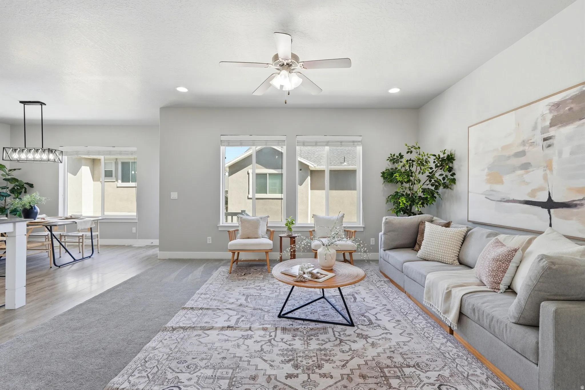 Recessed lighting illuminates the living space with a ceiling fan