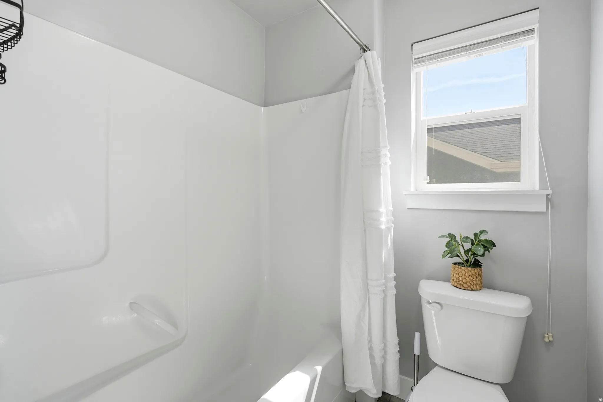 White shower-tub combination with a white shower curtain