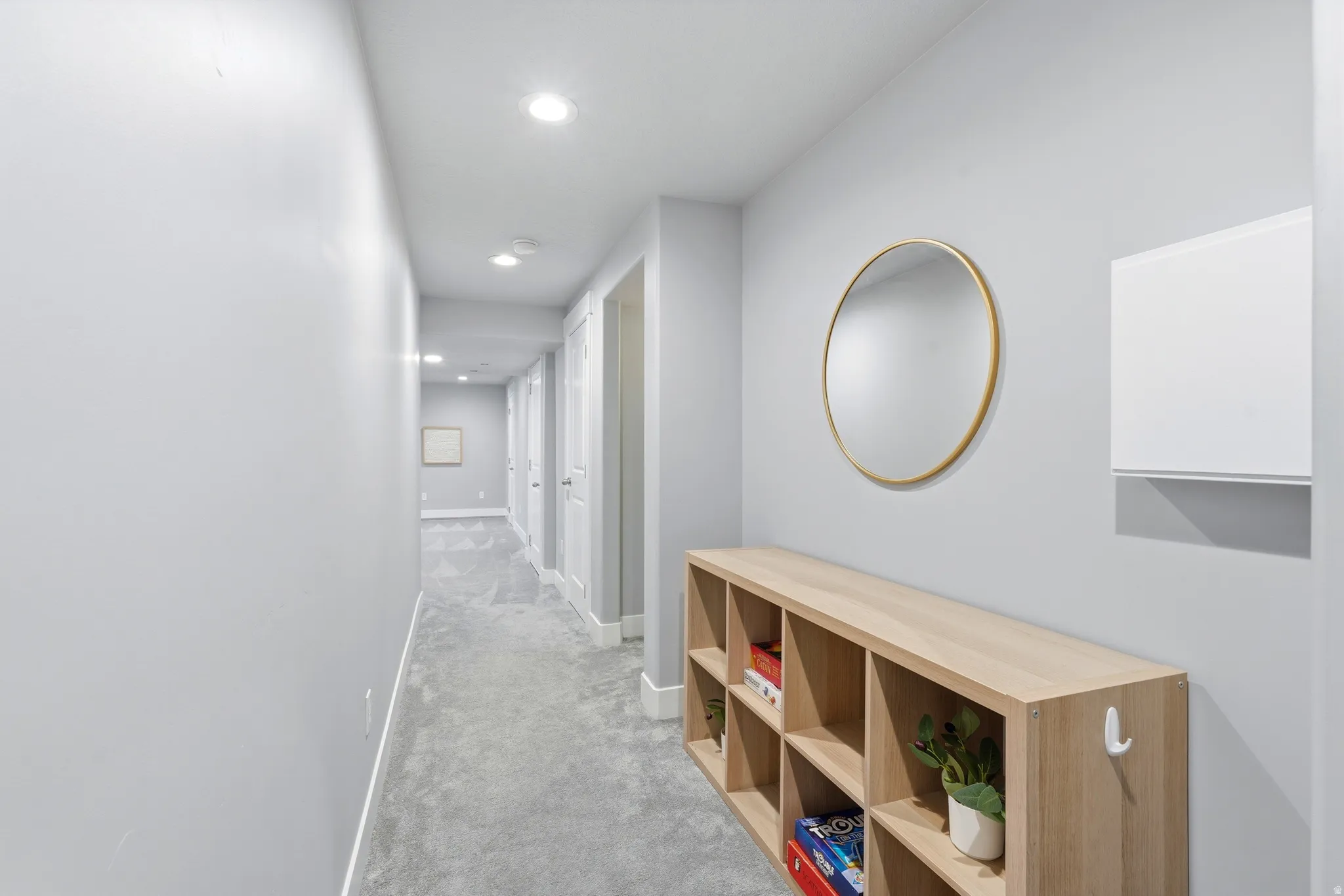 Hallway featuring recessed lighting, paneled doors, and carpeting