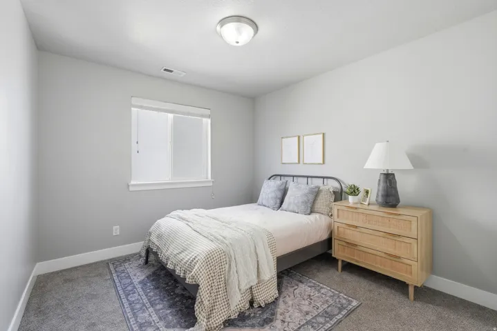 Recessed window with white trim, gray wall paint, and gray carpeting