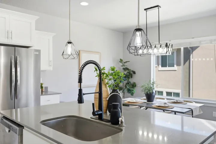 Kitchen island with an undermount sink and matte black pull-down faucet