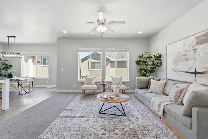 Recessed lighting illuminates the living space with a ceiling fan