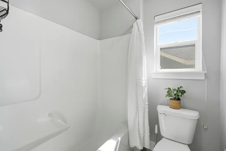 White shower-tub combination with a white shower curtain