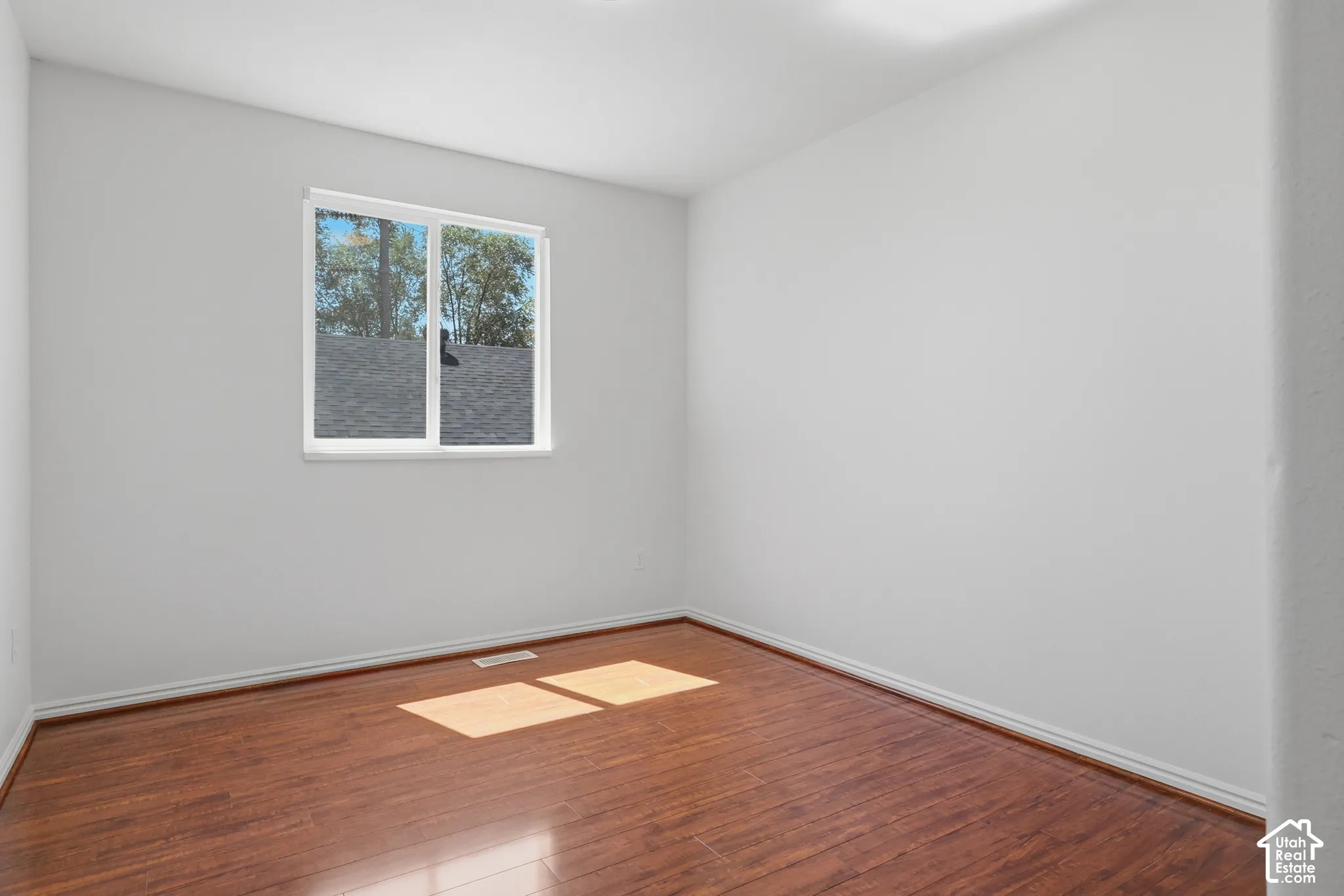 White walls with wood-finish flooring