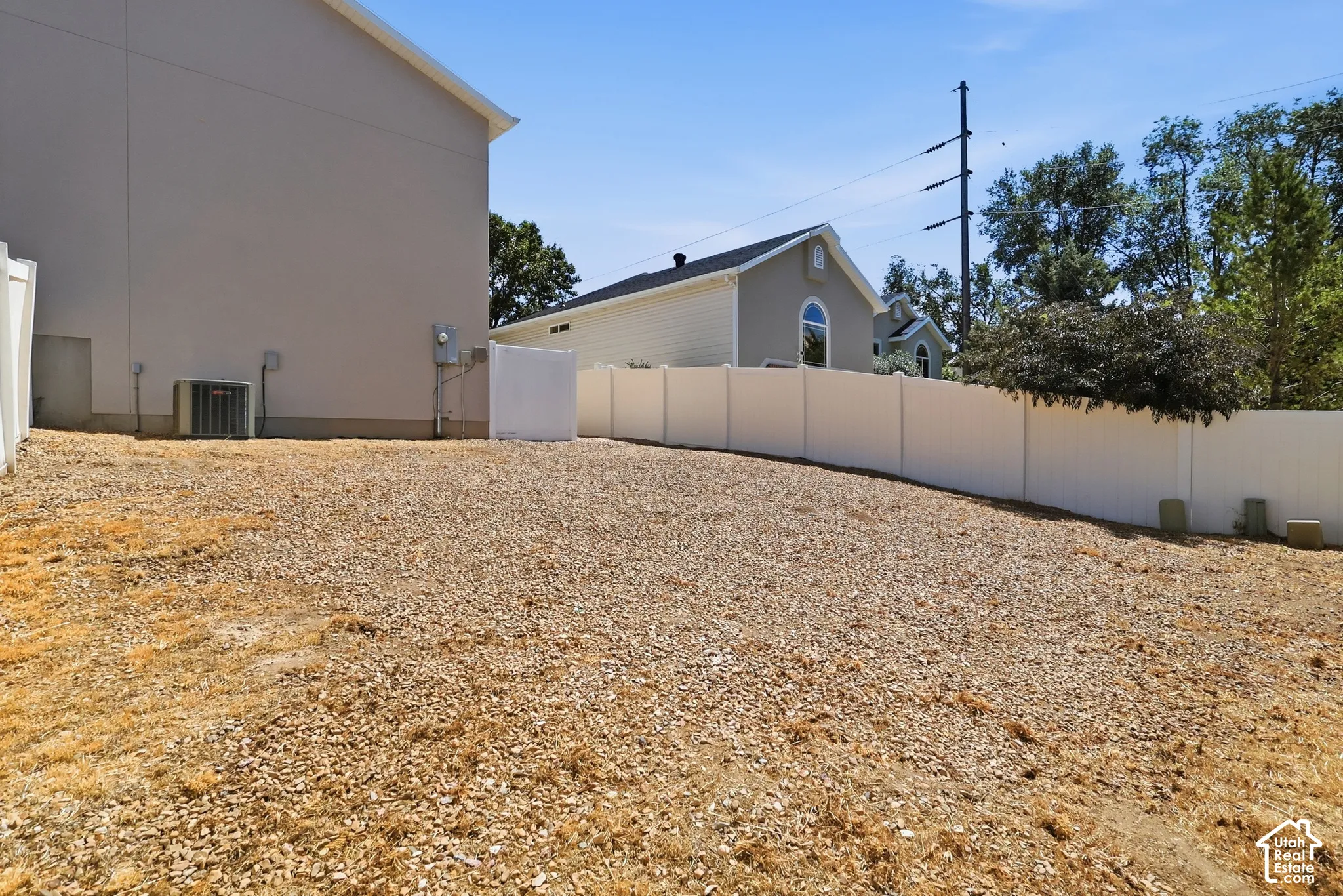 Gravel landscaping with a vinyl privacy fence