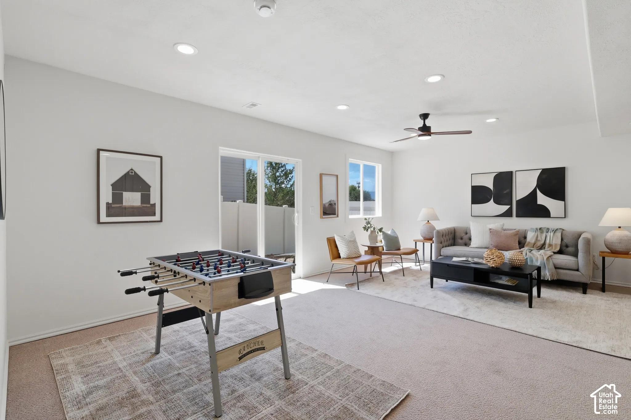Recessed lighting, ceiling fan, sliding glass door, and two windows provide natural light