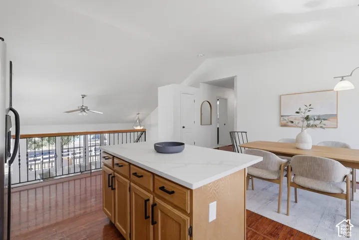 Kitchen island with light wood-finish cabinetry and a light-toned countertop