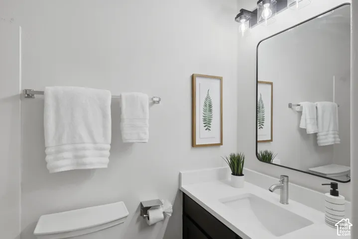 Modern vanity with a rectangular undermount sink, white countertop, and brushed nickel faucet