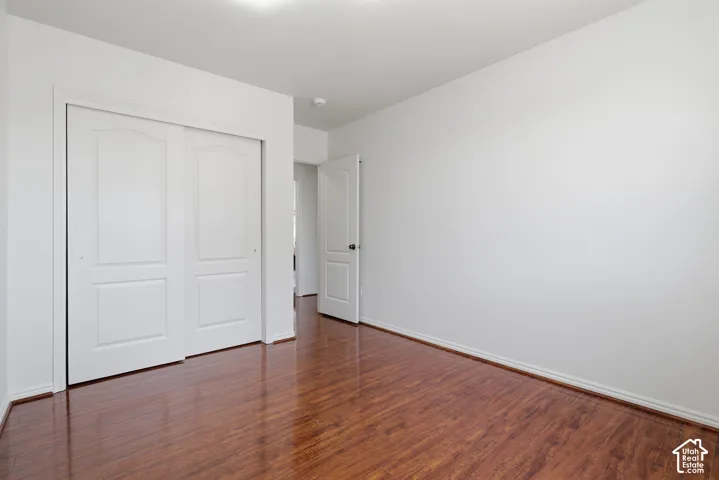Rich wood-finish flooring with white trim