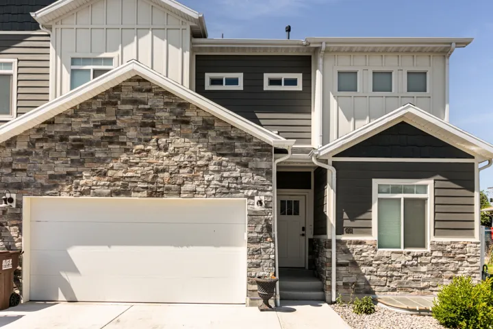 Multi-level exterior featuring stone veneer and horizontal siding