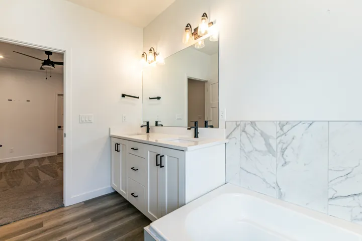 Dual vanity with white cabinetry and black hardware