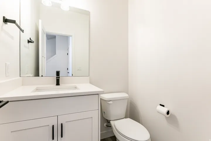Vanity with a white countertop and integrated rectangular sink