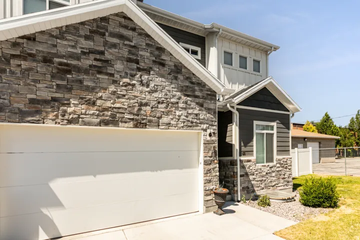 Exterior featuring stone veneer and dark siding accents