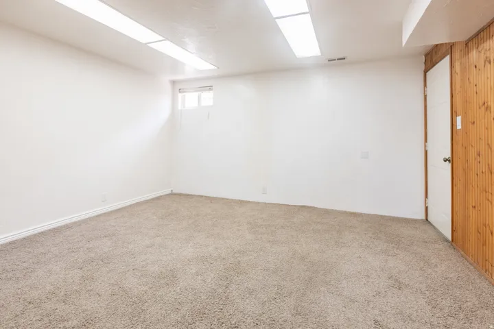 Neutral tone wall finishes, soft pile carpeting, and built-in flush lighting