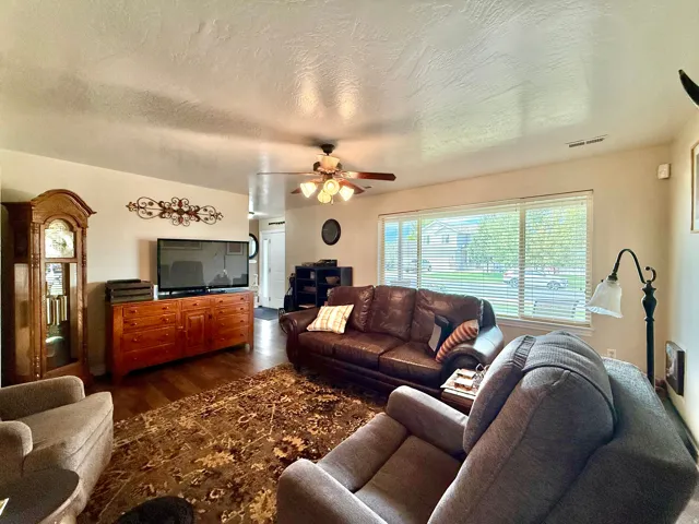 Hardwood-finish flooring, recessed lighting, and a ceiling fan with integrated lighting