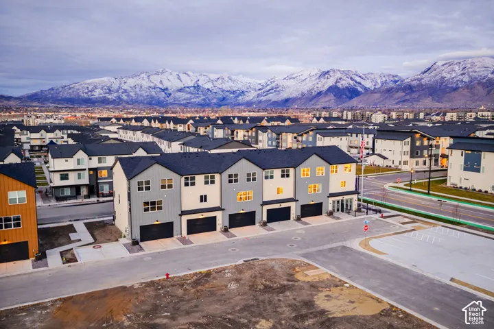 Multi-level townhome-style residences with dark roofs and light siding