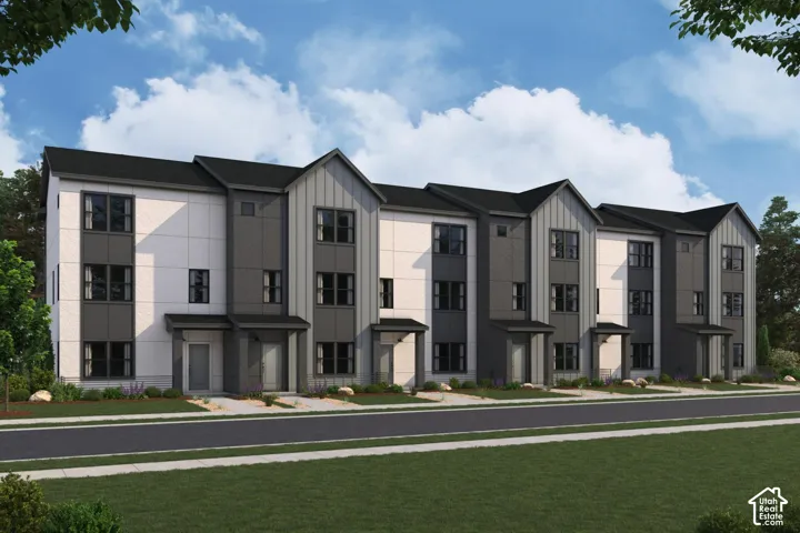 Modern townhome facade featuring a varied material palette, prominent gabled rooflines, dark-framed windows, and covered entryways
