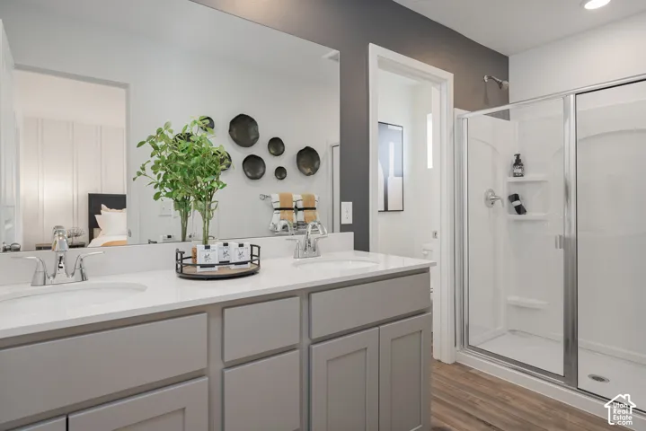 Dual vanity with undermount sinks, chrome faucets, and light gray cabinetry