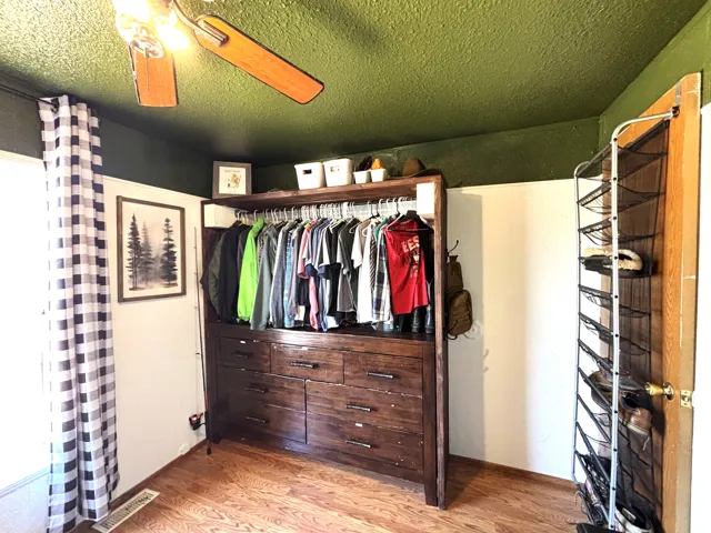 Wood-finish flooring with a ceiling fan light fixture