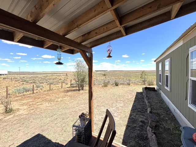 Wood-framed covered porch with a metal roof