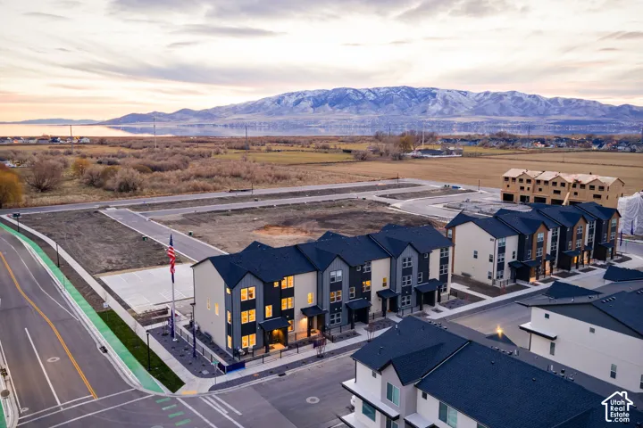 Newly constructed multi-story residences featuring dark roofs and varied exterior finishes