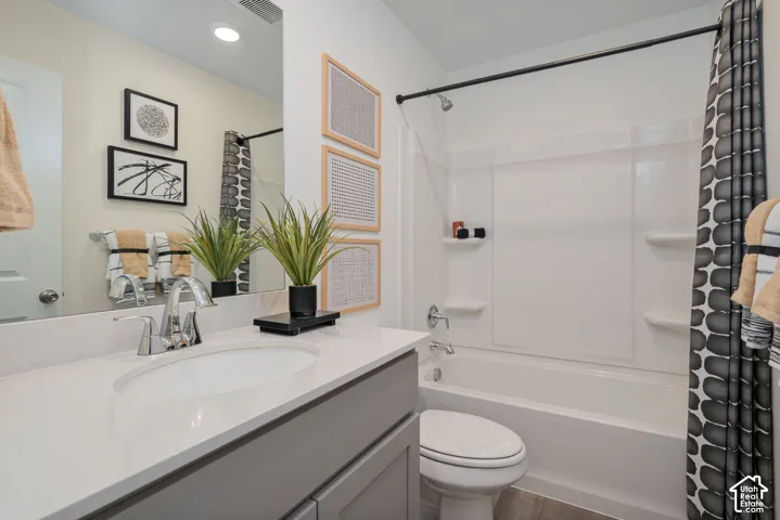 Vanity with an integrated sink, polished chrome faucet, and a large wall-mounted mirror