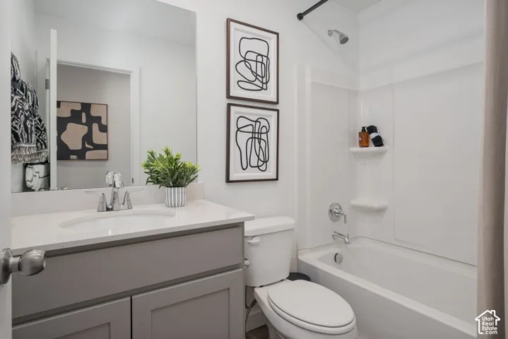 Bathroom featuring a single-sink vanity with a light-toned countertop, integrated sink, and chrome faucet
