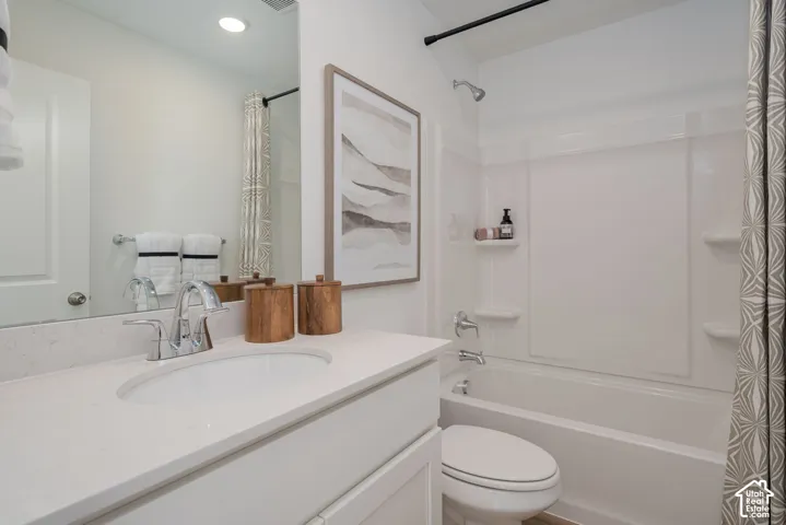 White vanity with an integrated sink, polished chrome faucet, and spacious countertop