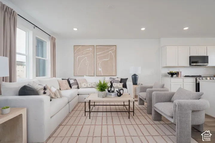 Open-concept living space featuring recessed lighting, double-pane windows, and wood-finish flooring