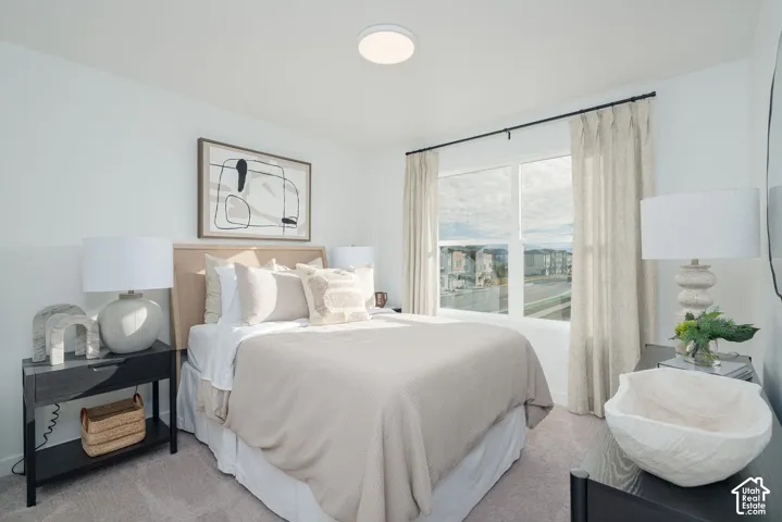 Recessed lighting illuminates a space featuring a large window and a neutral color palette