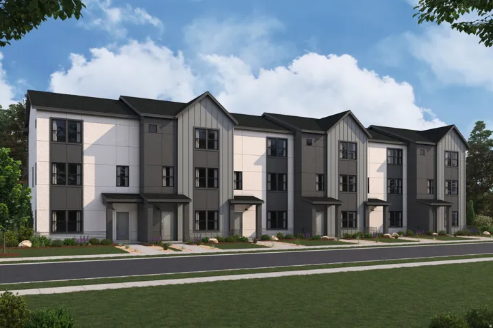 Contemporary townhome row featuring multi-story design, dark framed windows, integrated overhangs, and a clean-lined facade