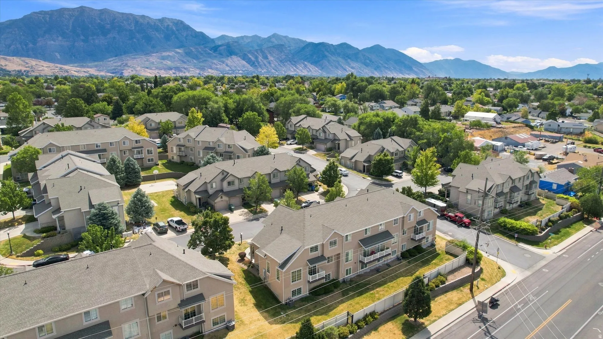 Expansive community with multi-level residences, balconies, and mountain scenery