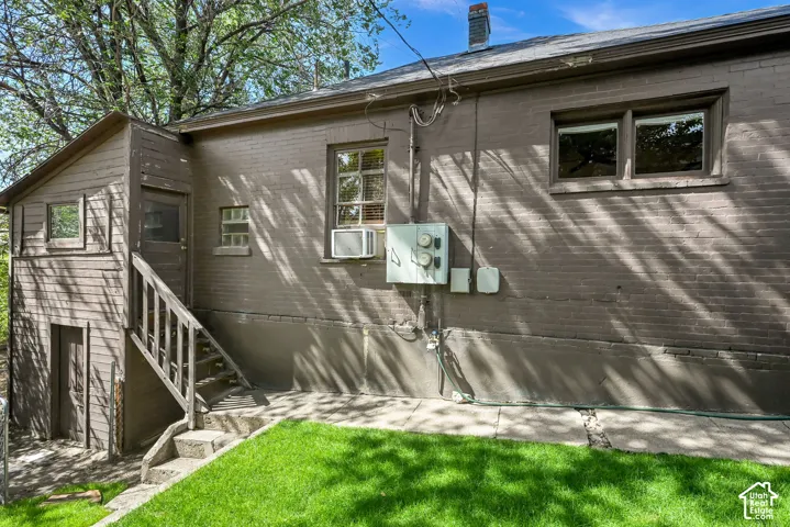 Exterior brick and wood siding with multiple window placements