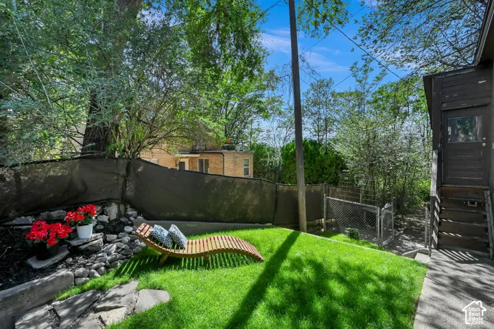 Expansive green lawn with a rock garden and established trees