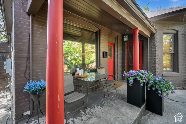 Brick exterior with red accent pillars and a contrasting red door