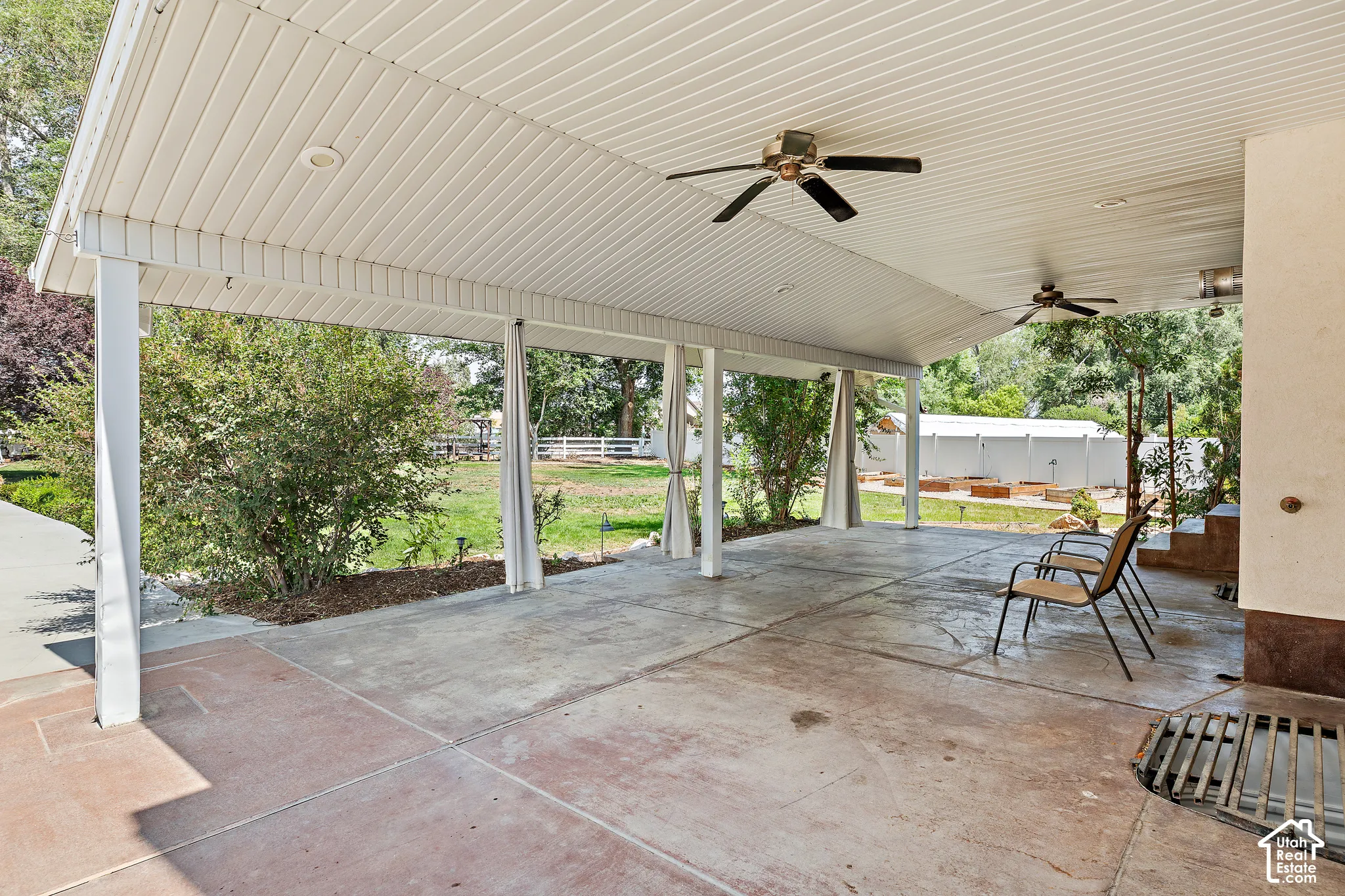 Covered patio with multiple ceiling fans, recessed lighting, and a concrete surface