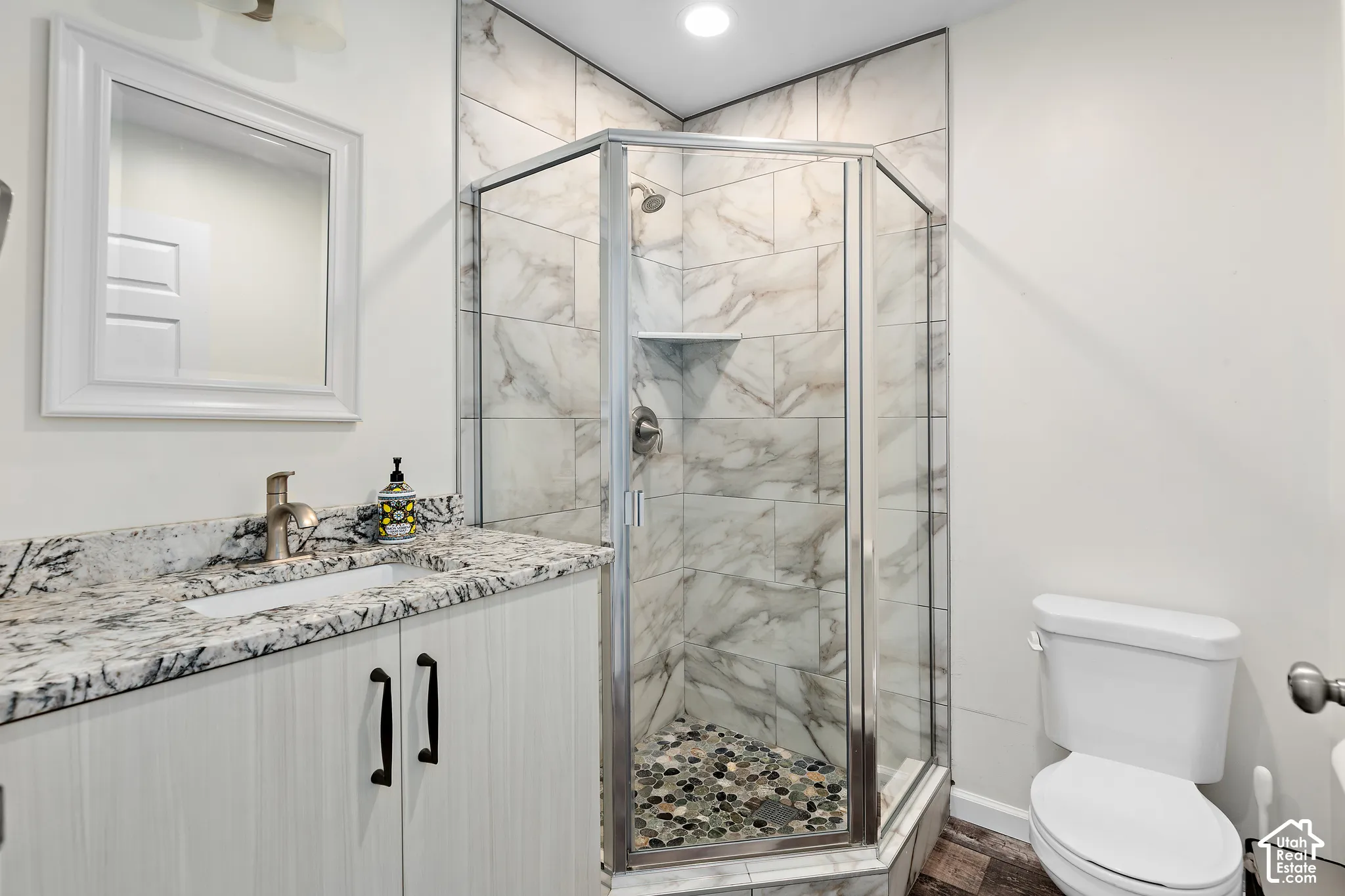 FLEX LIVING RV garage single bed bathroom walk-in shower with tiled walls and pebble-finish floor