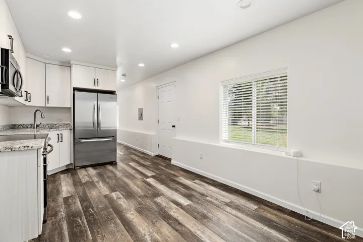 FLEX LIVING RV garage single bed kitchenette featuring light-toned cabinetry, stainless steel appliances, and stone-finish countertops