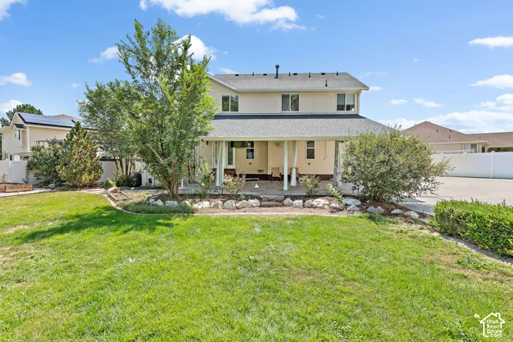 Expansive green lawn with mature trees and established landscaping