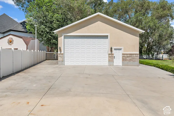Heated RV garage with an overhead garage door, side entry door and ample parking.