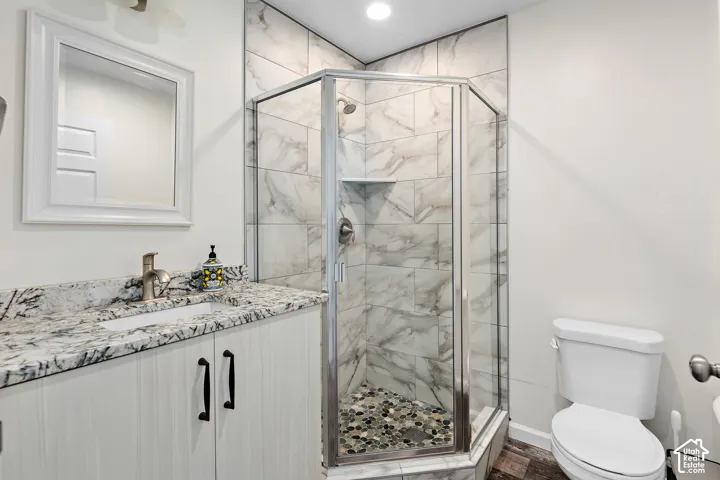 FLEX LIVING RV garage single bed bathroom walk-in shower with tiled walls and pebble-finish floor