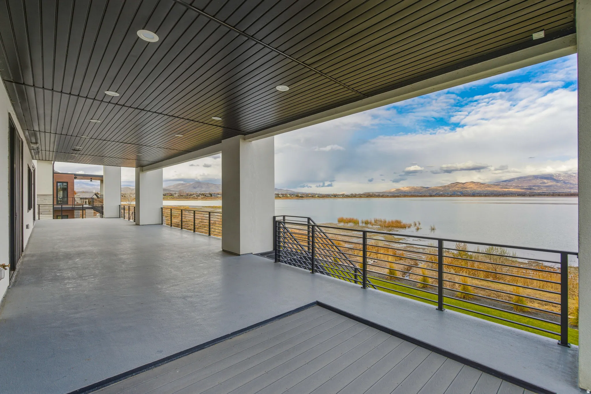Expansive covered patio with a textured ceiling and recessed lighting