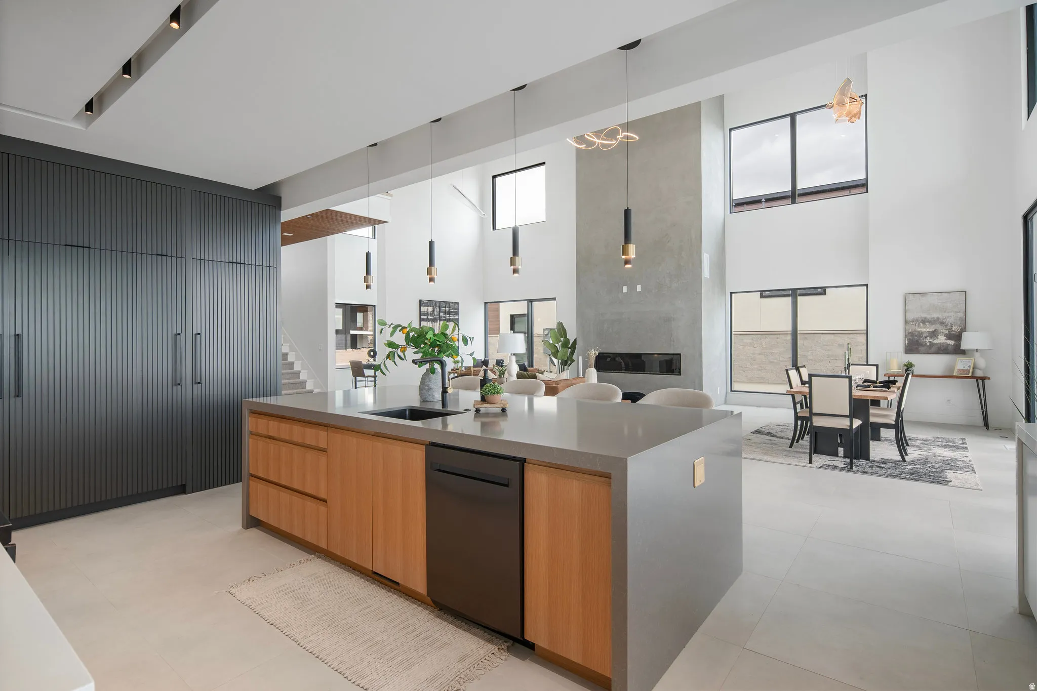 Gourmet kitchen with a large central island, integrated appliances, and floor-to-ceiling cabinetry