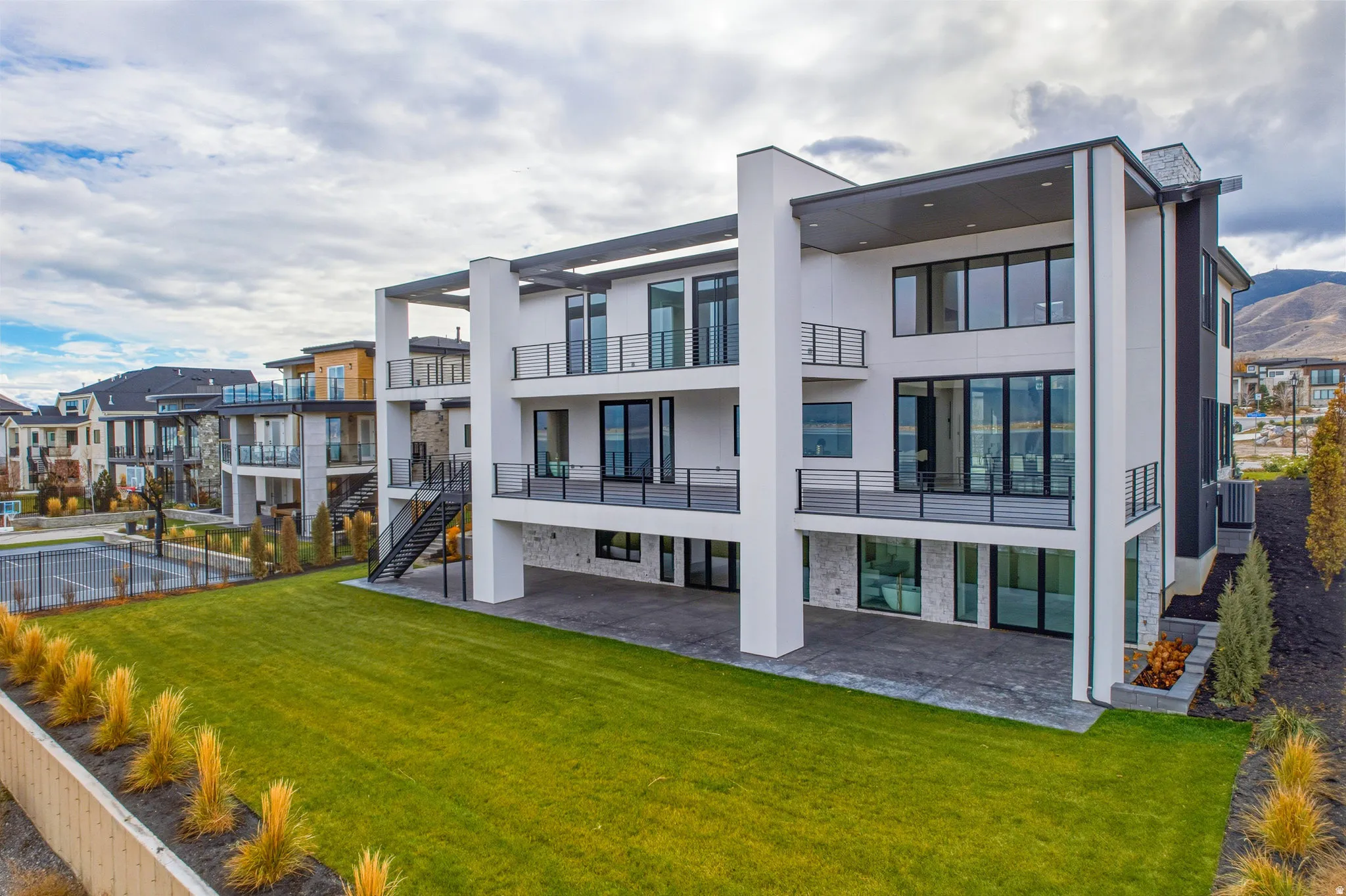 Contemporary multi-story exterior with multiple balconies and a covered patio