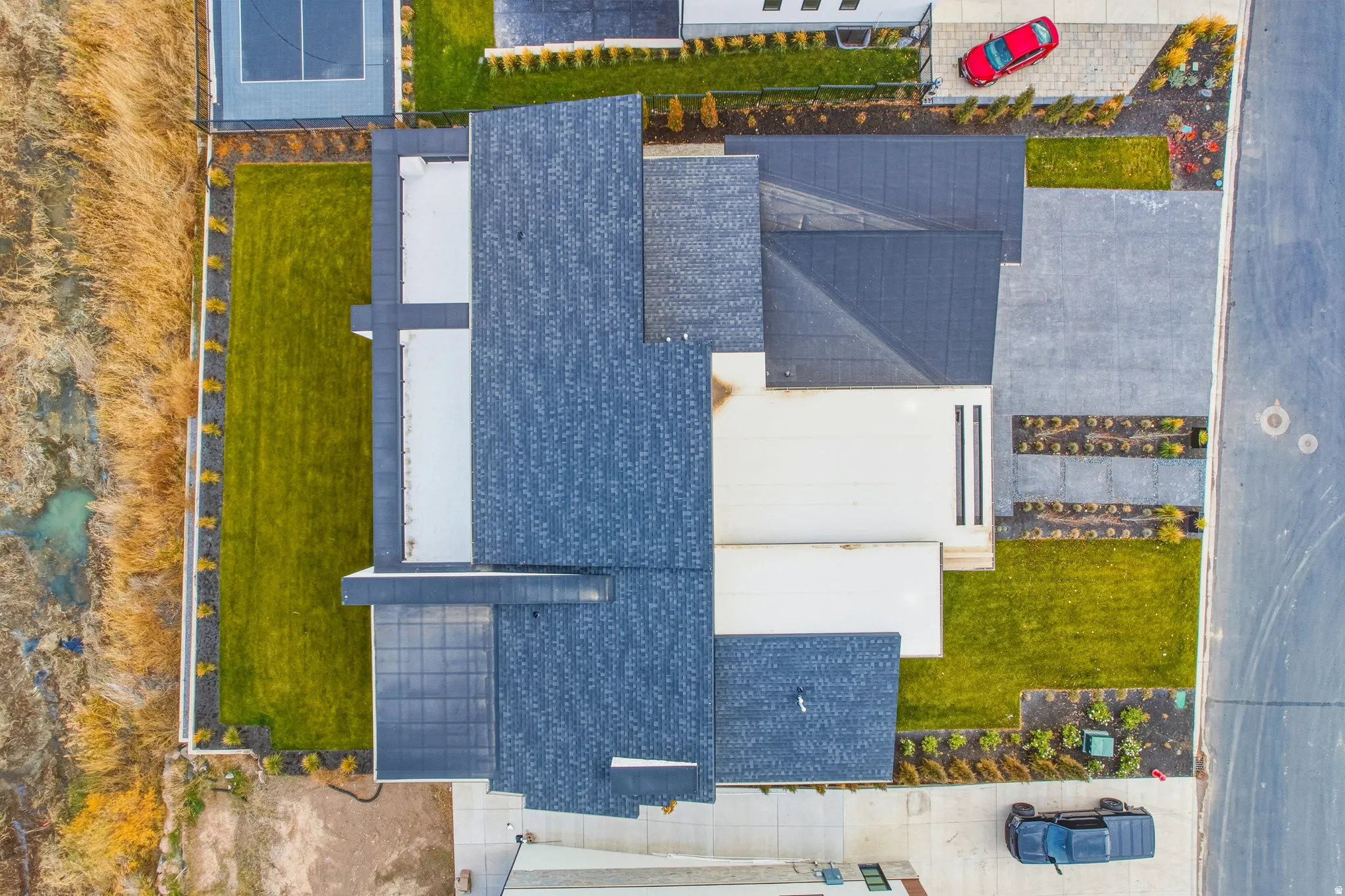 Modern exterior with varied rooflines, manicured lawns, and paved pathways