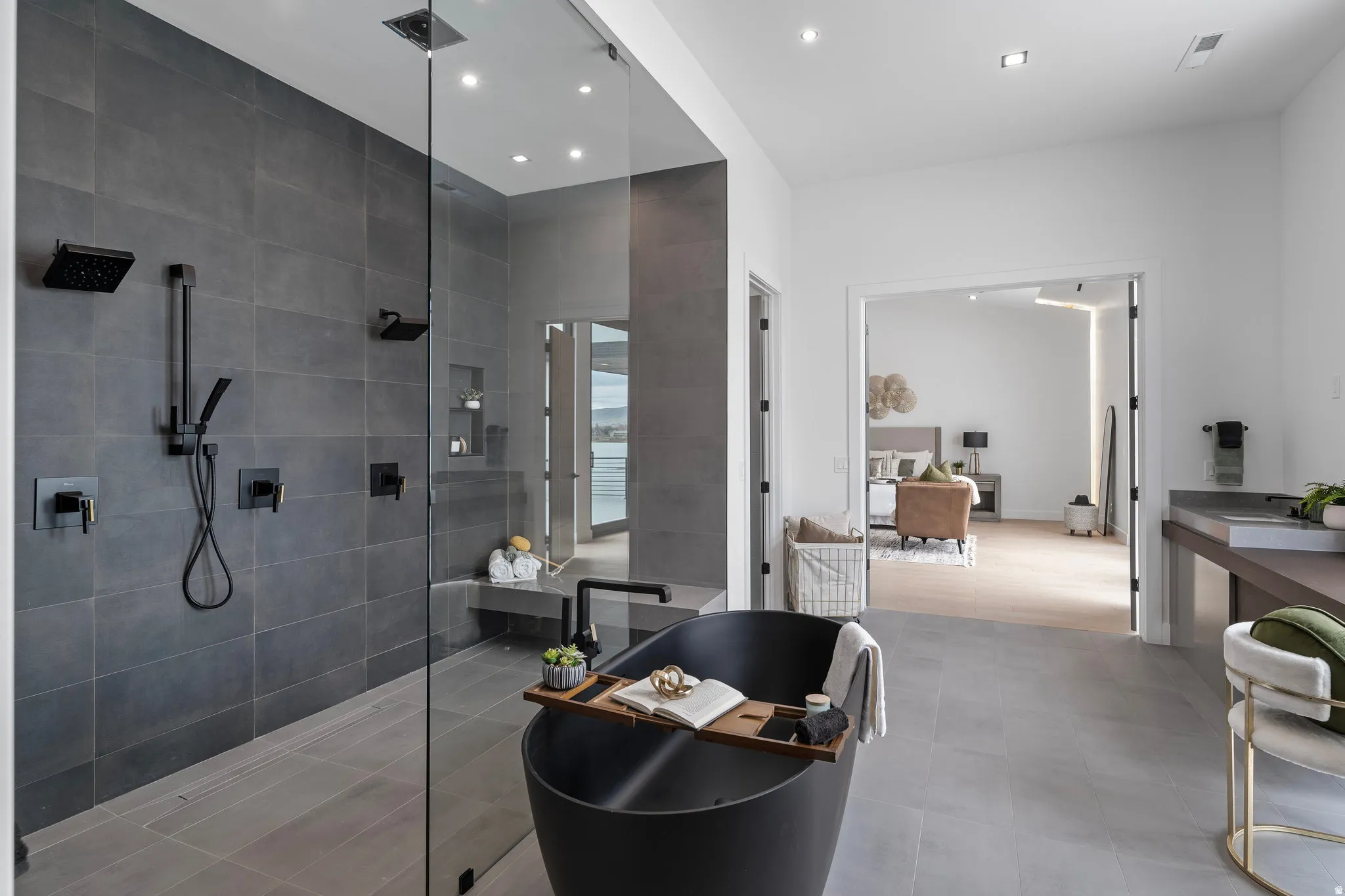 Glass-enclosed shower with multiple matte black fixtures and built-in bench